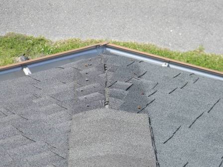 View of missing ridge shingles on the lower roof area at the east end ...